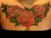 girl's chest rose tattoo